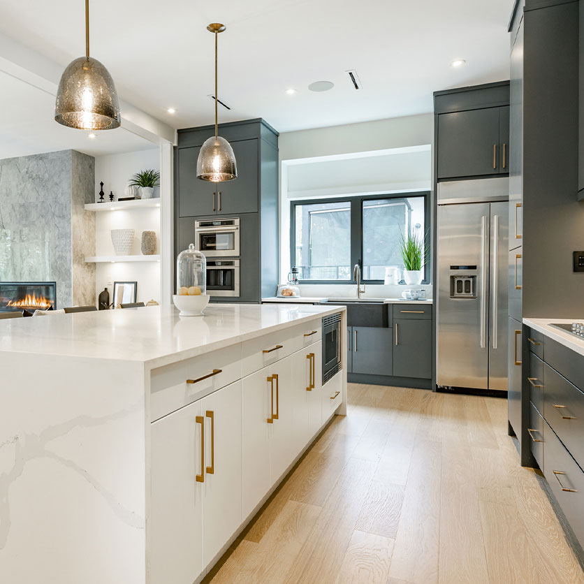 Luxury kitchen featuring custom under cabinetry lighting, pendant lights and tasteful brass finishes.