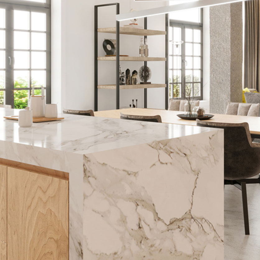 Kitchen with a large marble waterfall island countertop